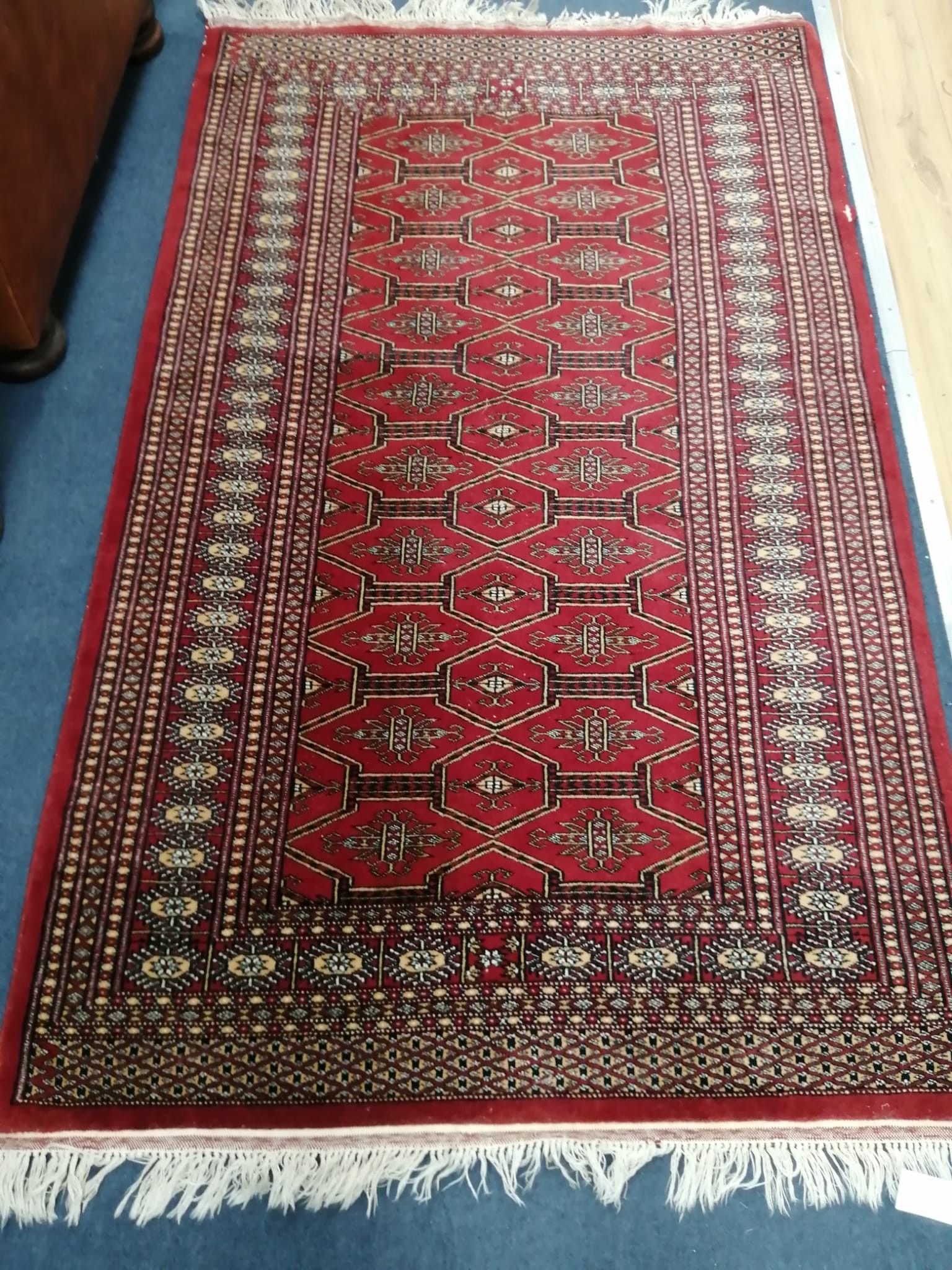 A Bokhara red ground rug, 164 x 100cm